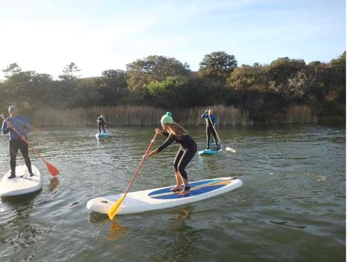 a group of people on paddle boards in the water at Villa Rio by Valada Village in Valada