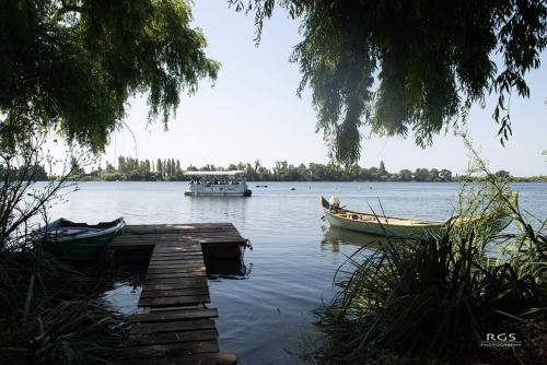 a boat is docked on a lake with a dock at Villa Rio by Valada Village in Valada