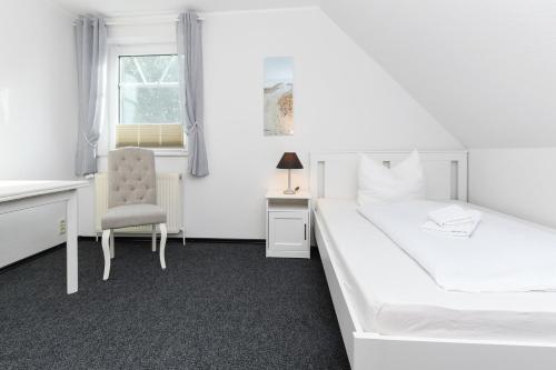 Ένα ή περισσότερα κρεβάτια σε δωμάτιο στο Hotel-Pension Janssen - Gästehaus Huus an't Deep