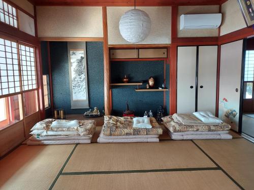 a large room with four beds in a room at 泰山木美山 in Nantan city