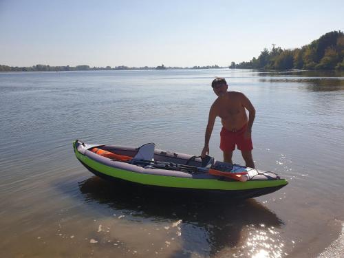a man standing next to a boat in the water at Villa Rio by Valada Village in Valada