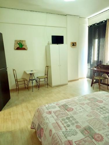 a bedroom with a bed and a table and chairs at Badia in Aversa