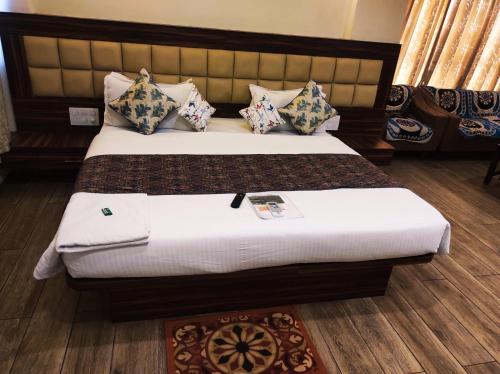 a bedroom with a bed with pillows on it at Manasi Pride in Satara