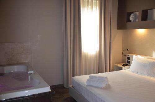 a hotel room with a bed and a sink at Best Western Plus Hotel Terre di Eolo in Patti