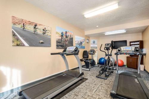 a gym with two treadmills and two exercise bikes at Clarion Suites St George - Convention Center Area in St. George