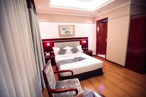 a hotel room with a bed and a chair at Base Ethiopia International Hotel in Addis Ababa
