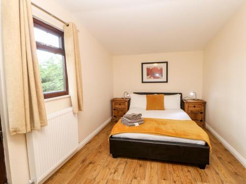 a bedroom with a bed and a window at Daffodil Lodge in Saltburn-by-the-Sea
