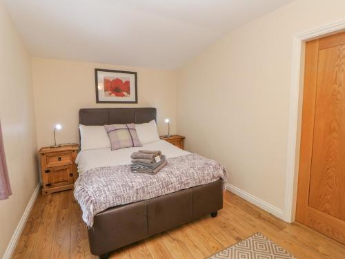 a bedroom with a bed and a wooden floor at Orchid Lodge in Saltburn-by-the-Sea