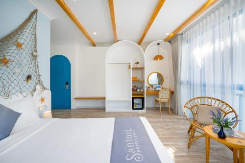 a bedroom with a bed and a dining room at Santori Hotel And Spa in Da Nang