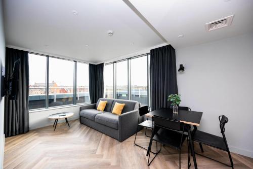 a living room with a couch and a table at Staycity Aparthotels Dublin Tivoli in Dublin