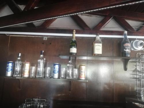 a bar with bottles of alcohol on a shelf at Santana Hotel in Beldibi