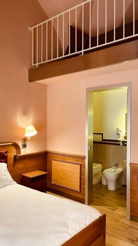 a bedroom with a bunk bed and a bathroom at Le Club Boutique Hotel in Lecce