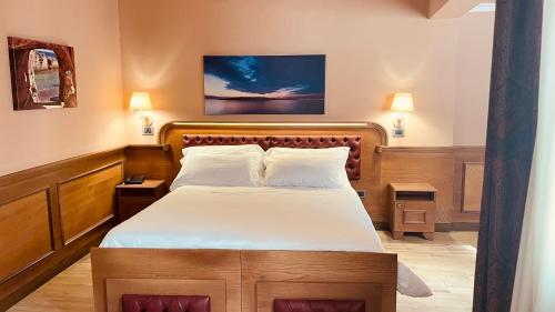 a bedroom with a large bed with white sheets at Le Club Boutique Hotel in Lecce