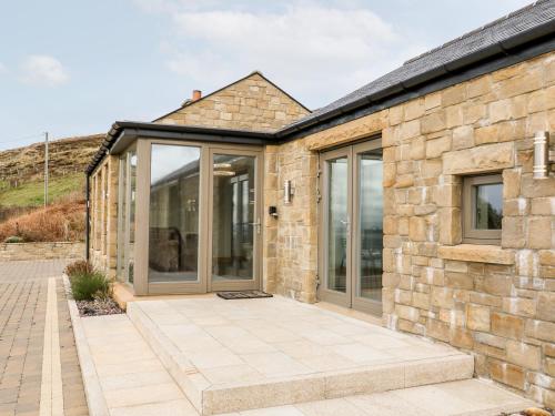 an internal view of a stone house with sliding glass doors at House Crohy Head in Dungloe