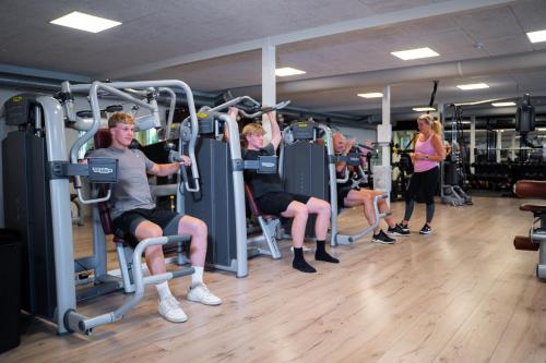 a group of people sitting on the gym machines at SportsPark Blaavandshuk Resort in Oksbøl