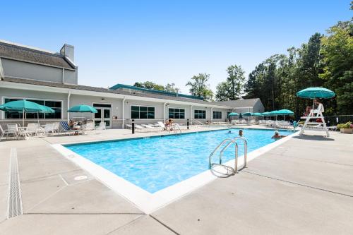a large swimming pool with people in the water at Sea Colony - 4203 Rally in Bethany Beach