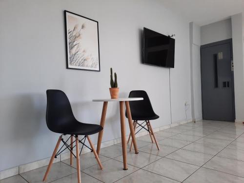 a table and two chairs in a room at Ntemos Apartments in Tolo