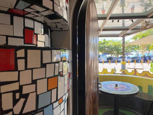 a room with a wall with a table and a patio at Mini Summer in Nanwan