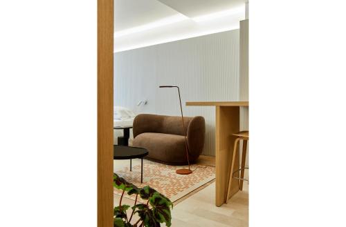 a living room with a chair and a table at 60 Balconies Iconic in Madrid