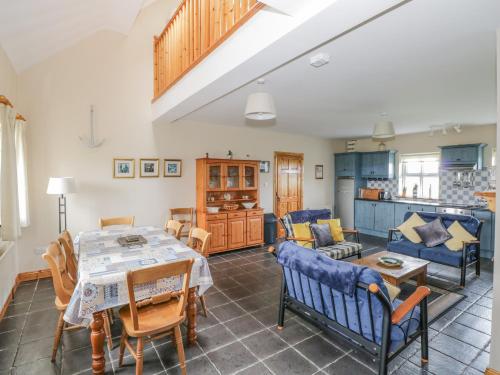 a living room with a table and chairs at 8 Lios Na Sioga in Belmullet