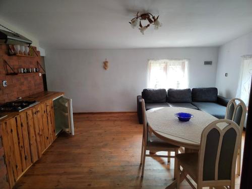 a living room with a table and a couch at Agroturystyka UL in Nowe Worowo