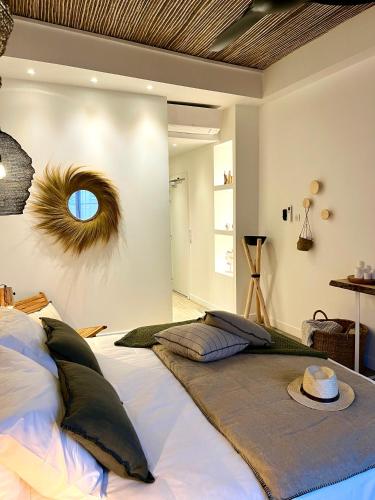 a bedroom with a large bed with a hat on it at Le S in Argelès-sur-Mer
