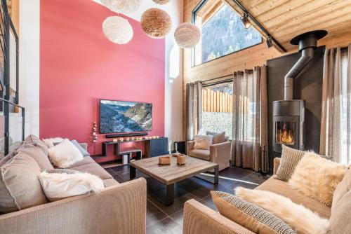 a living room with a couch and a table at Chalet Azobe Morzine - by EMERALD STAY in Montriond