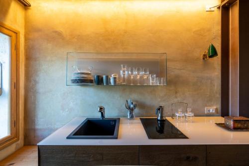 a kitchen with a sink and a counter with glasses at Il Molino in Asolo