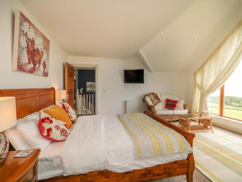 a bedroom with a large bed and a window at Millers Lane House in Aught Upper