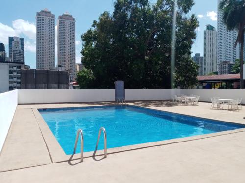 a swimming pool on the roof of a building at Hotel Tower House Suites in Panama City