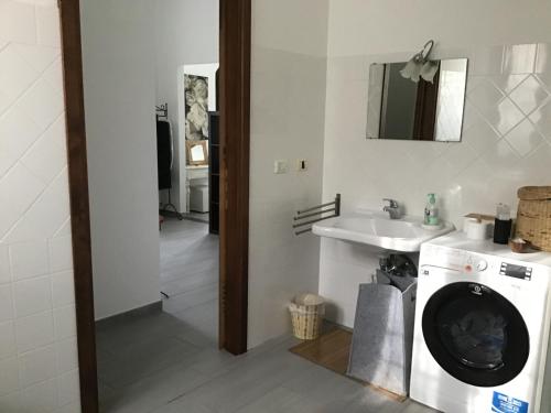 a bathroom with a washing machine and a sink at Azienda Agrituristica Santissima Trinità in Budrio