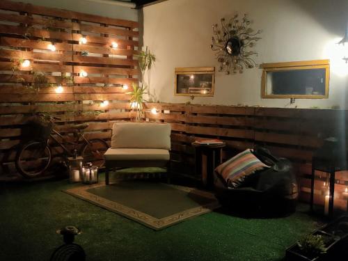 a room with a chair and a bike and lights at Herama House in Vila Nova de Gaia