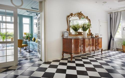 a room with a mirror and a checkered floor at Villa Antonina in Sopot