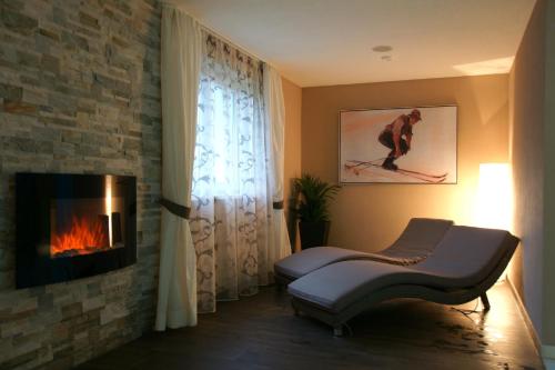 a living room with a fireplace and a couch at Sportalm in Sölden