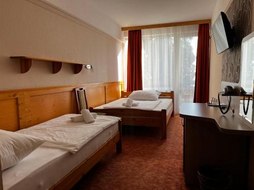 A bed or beds in a room at Nereus Park Hotel