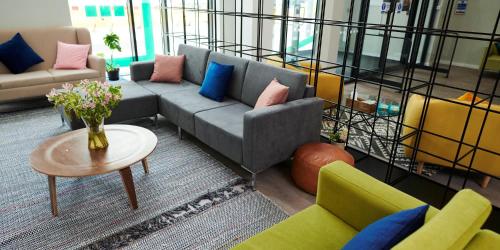 a living room with a couch and chairs and a table at Student Only Canvas Walthamstow in London in London