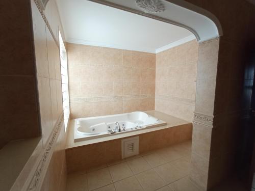 a bathroom with a bath tub with a sink at VILLA MARTA in Playa Blanca