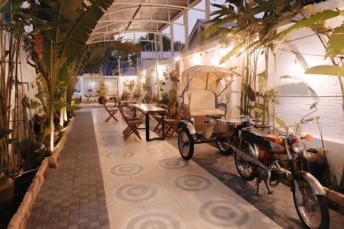 a carriage parked in a room with plants at Bich Ngoan HOTEL in Trà Vinh