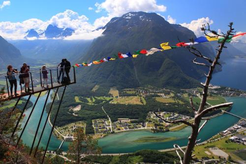 a group of people standing on a suspension bridge over a mountain at Molde Vandrerhjem Hostel in Molde