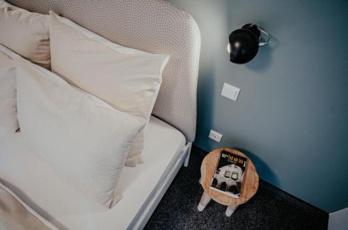 a bedroom with a bed with a pillow and a toy at Alpenrose Bayrischzell Hotel in Bayrischzell