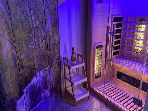 a purple room with a bottle of wine on a shelf at Apartment am Wasserfall - Erholung in Top-Lage in Feldberg