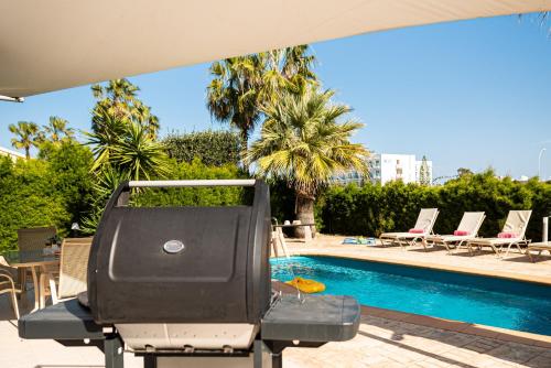 a swimming pool with a lounge chair next to a pool at Protaras View Villas in Protaras