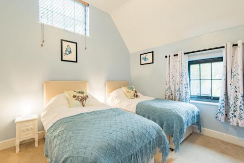 a bedroom with two beds and a window at The Kennels by Bloom Stays in Faversham