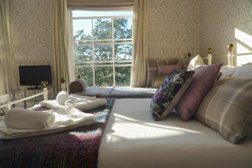 a bedroom with a bed with towels and a window at Castle House Guest House in Dover