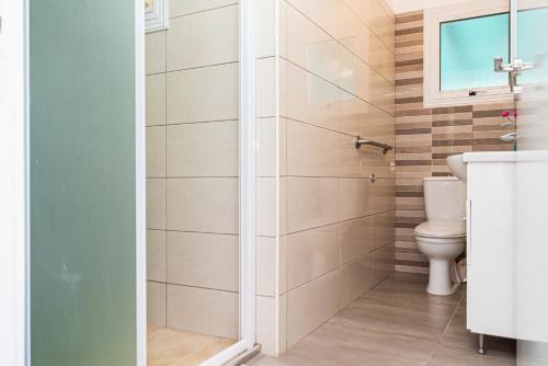 a bathroom with a toilet and a shower at Protaras View Villas in Protaras