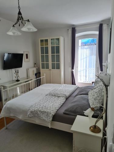 a bedroom with a large bed and a window at Villa Bariole in Bad Reichenhall