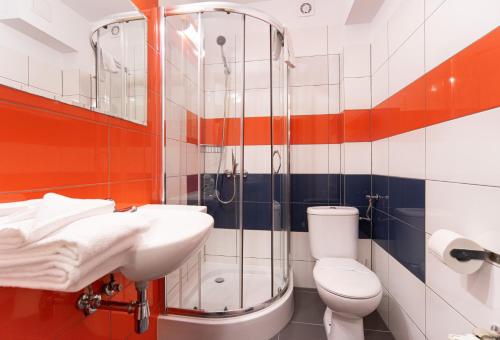 a bathroom with a toilet and a sink and a shower at Fala by Marena Wellness & Spa in Międzywodzie