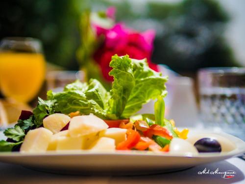 a plate of food with vegetables on a table at Hotel Monotel Dar El Barka in Nouakchott