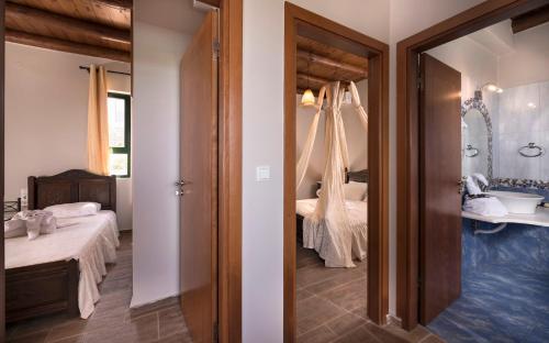 Kipárissos的住宿－Villa Kissos by PosarelliVillas，一间卧室配有床、水槽和镜子