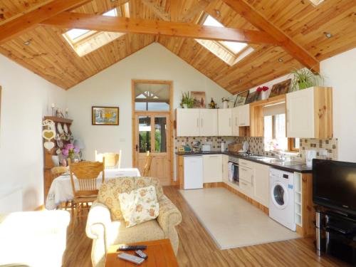 a kitchen with white cabinets and a wooden ceiling at 80 New Street in Lismore